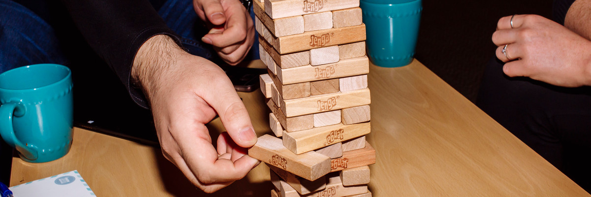 A group of people play Jenga.
