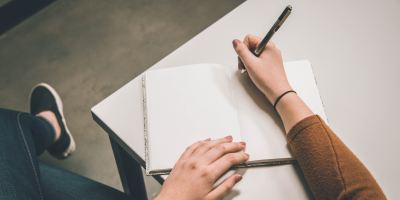 Person sat with notepad ready